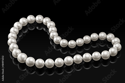 Luxury white pearl necklace on a black background with glossy reflection