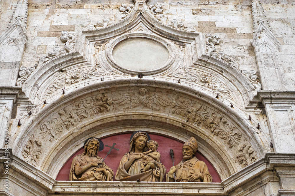 Montepulciano, province of Siena, Tuscany, Italy - detail of the facade of a church with marble sculpture in the city center