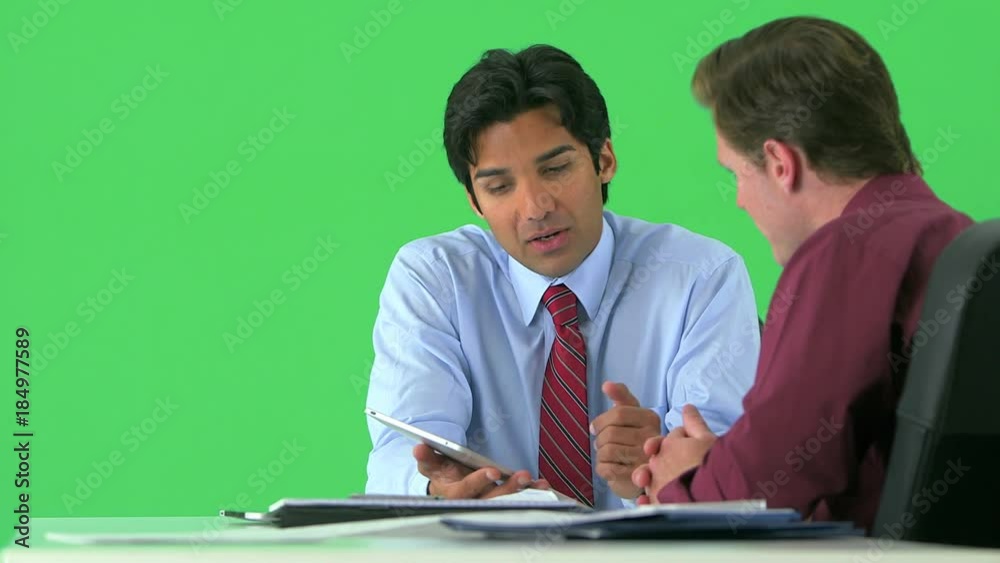 two businessmen working with tablet on greenscreen two businessmen working with tablet on greenscreen