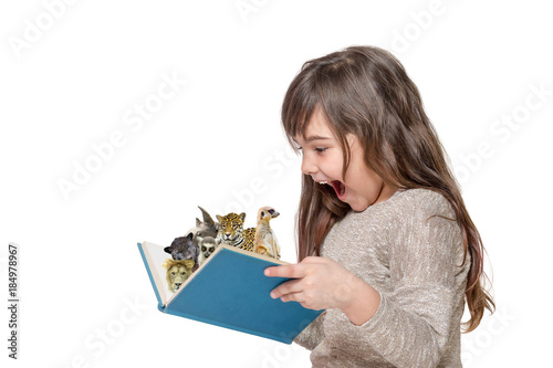 Side view of laughing surprised long haired little girl holding an open book with peeking animals . All is on the white background.