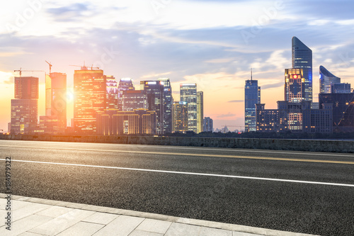 Asphalt highway and modern city buildings in hangzhou qianjiang new city at sunset photo