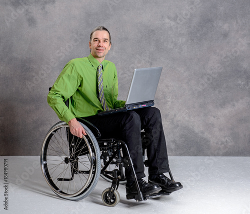 disabled business man in wheelchair with computer