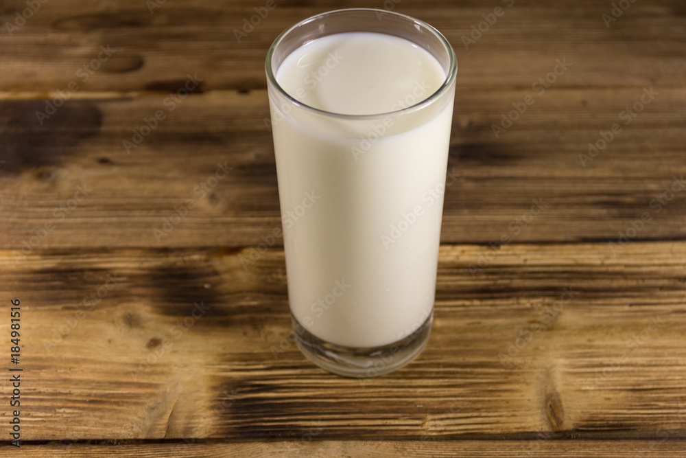 Glass of milk on wooden table Glass of milk on wooden table