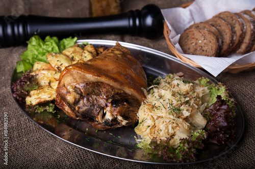 Canvas Print Roast pork knuckle with fried potato and sauerkraut