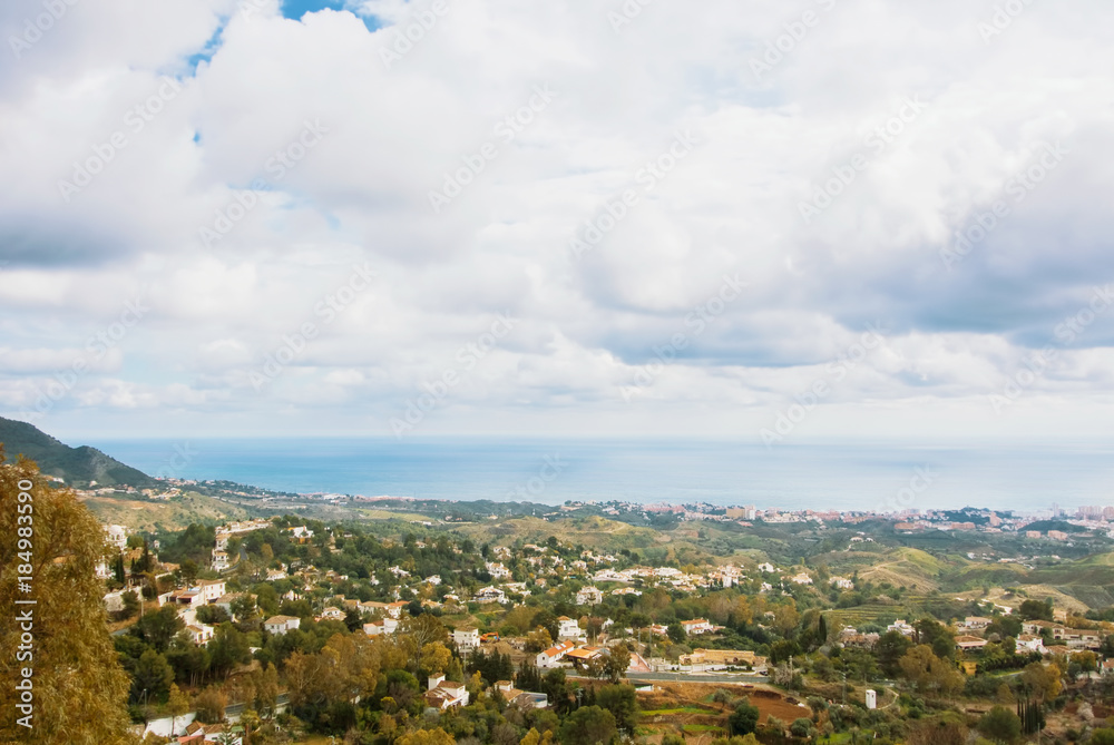 Aerial panoramic beautiful view from the park of Mijas, seascape of Mediterranean sea and surroundings of Fuengirola town on winter cloudy day, Andalusia, Spain.