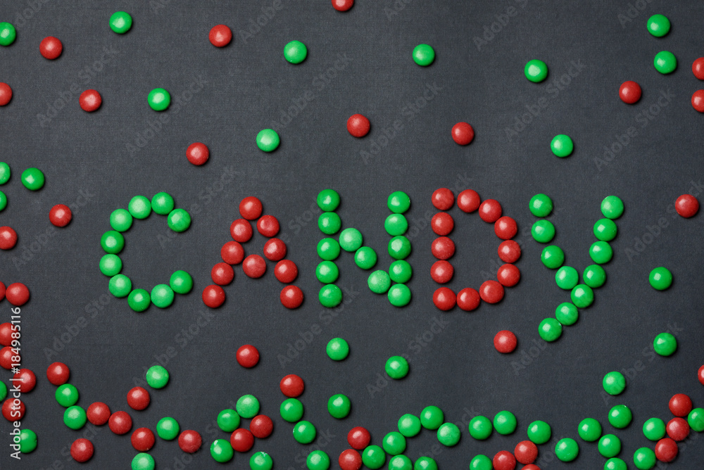 Green and red dragee candies. Word candy. Green and red dragee candies. Word candy.