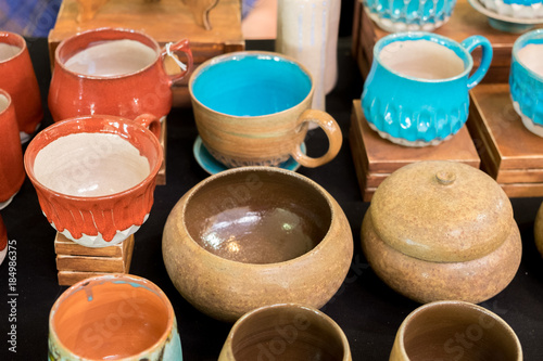 Vibrant colored pottery sold at handсraft market © vadiml