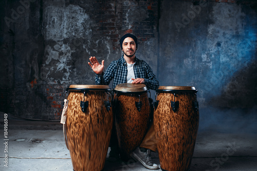 Canvas Print Drummer playing on wooden bongo drums, beat music
