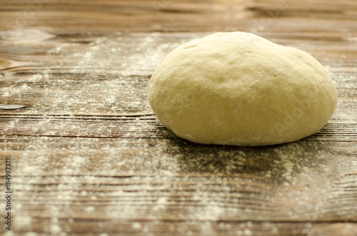 Dough on wooden background