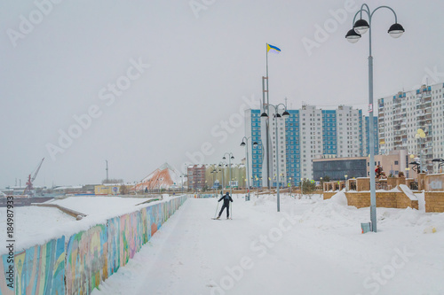 a man skis along the river photo