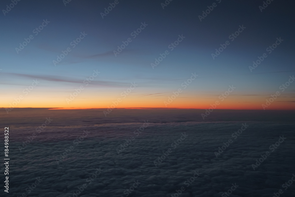 Fototapeta premium clouds in early morning during flight on a plane