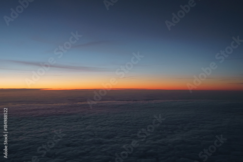 clouds in early morning during flight on a plane