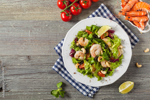 Shrimp salad with tomato, olives and cashew nuts.