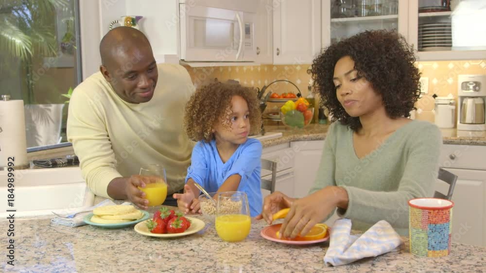 African American family being silly with food in kitchen African American family being silly with food in kitchen