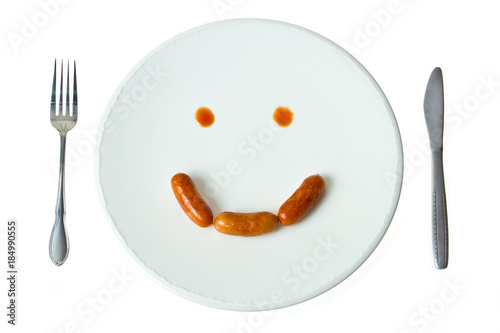 Smiling face sausage on the dish