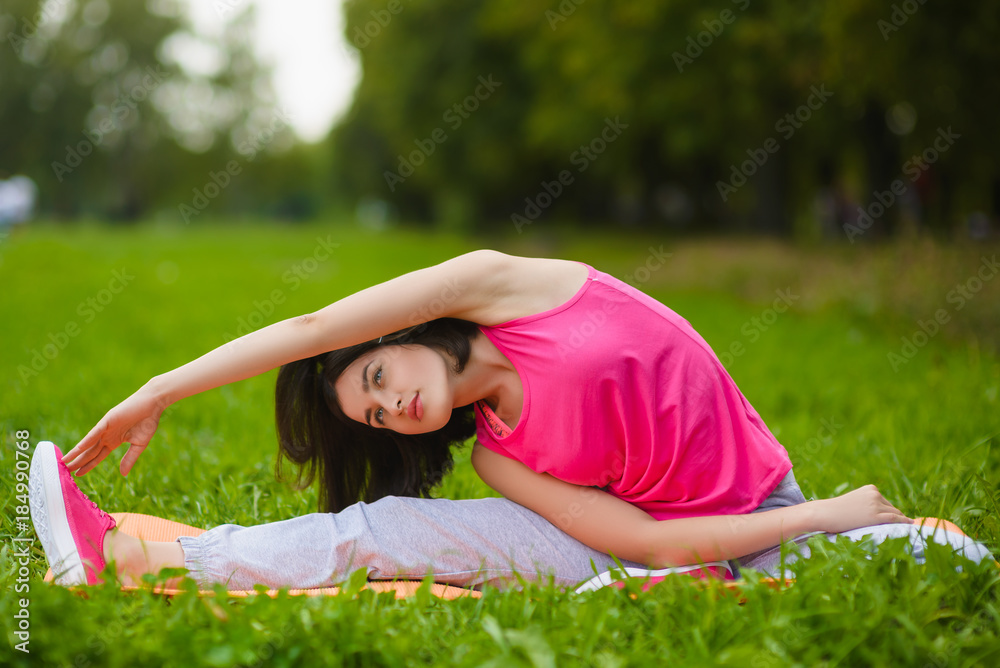 Fitness sport girl in sportswear doing yoga fitness exercise outdoor