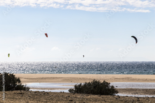 People practicing kiteboarding in the beach of Bolonia, outside of Tarifa, in Andalusia, southern Spain
