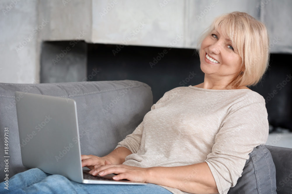 Mature woman working on laptop at home Mature woman working on laptop at home