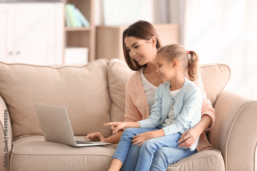 Busy young woman with daughter in home office