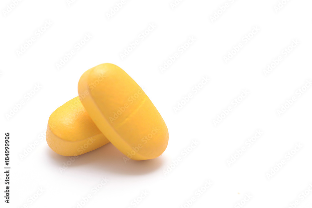 two yellow pills with copyspace