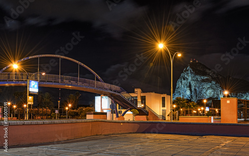 Night photo of small bridge with rock of Gibraltar on a background. Photo made from Spanish town La Linea de la Concepcion. 