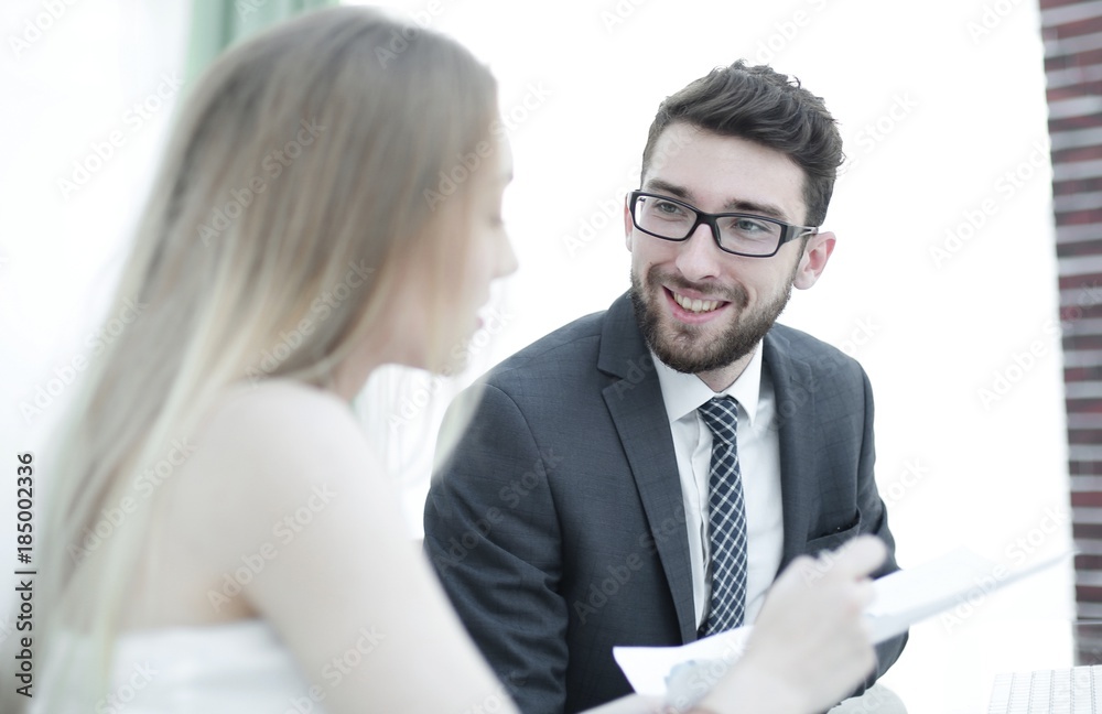 Senior manager and employee discussing financial documents Senior manager and employee discussing financial documents