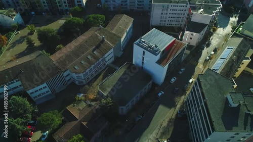 4K 50P (HFR) aerial of solar panel roof on building with car passing by