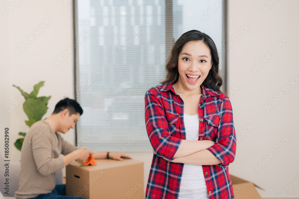 Portrait of happy woman during moving home carrying carton boxes Portrait of happy woman during moving home carrying carton boxes