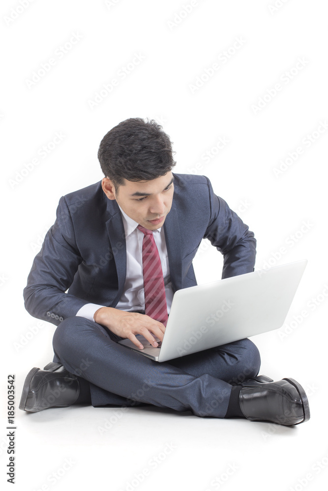 Businessman using laptop while sitting. Isolated on white background. Businessman using laptop while sitting. Isolated on white background.