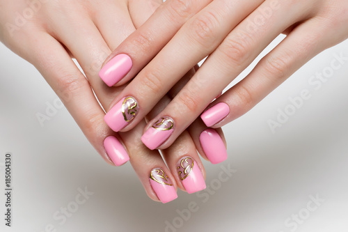 pink manicure with gold design on long square nails