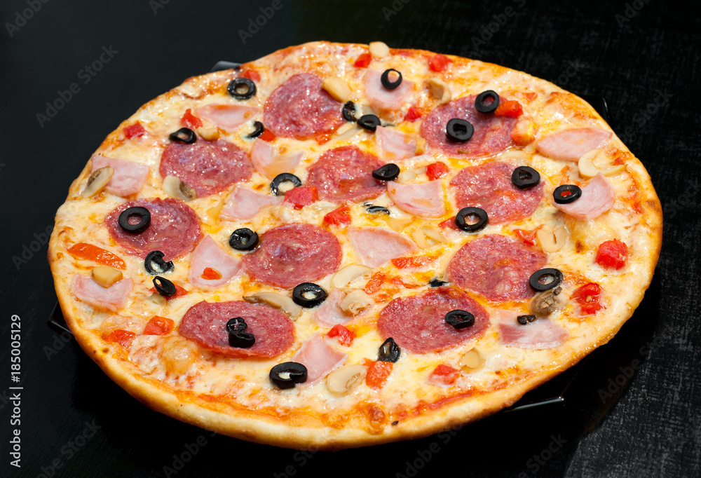 pizza with peperoni, mushrooms and ham