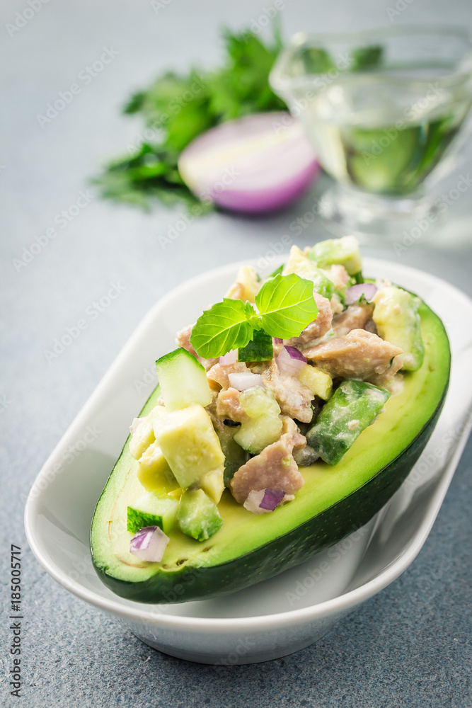 Tuna spinach avocado salad on concrete background. Selective focus, copy space. Tuna spinach avocado salad on concrete background. Selective focus, copy space.