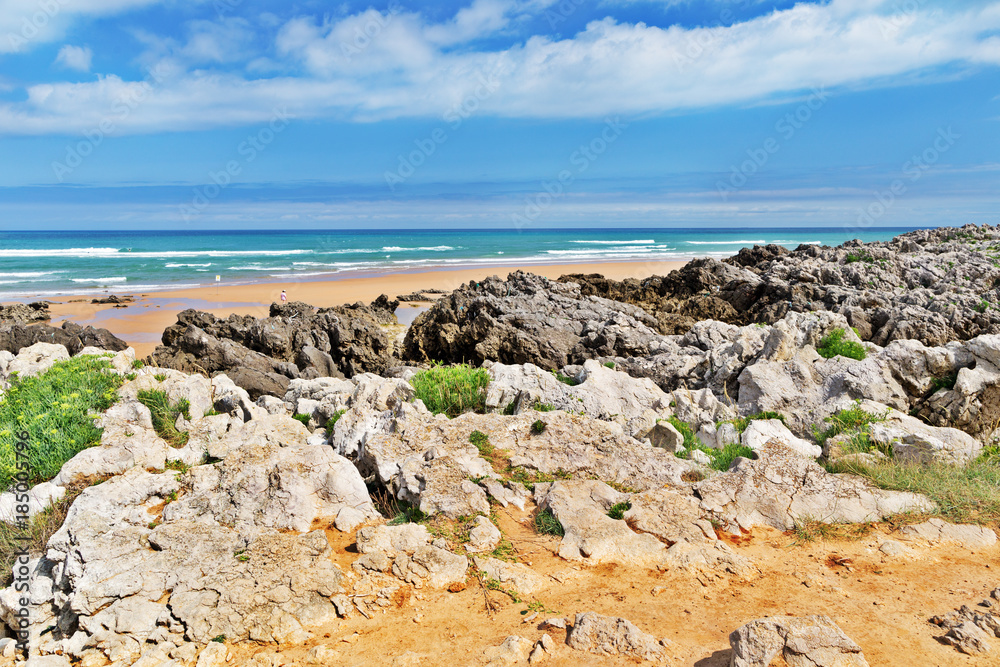 Strip of big stones on the sandy beach during an outflow Strip of big stones on the sandy beach during an outflow