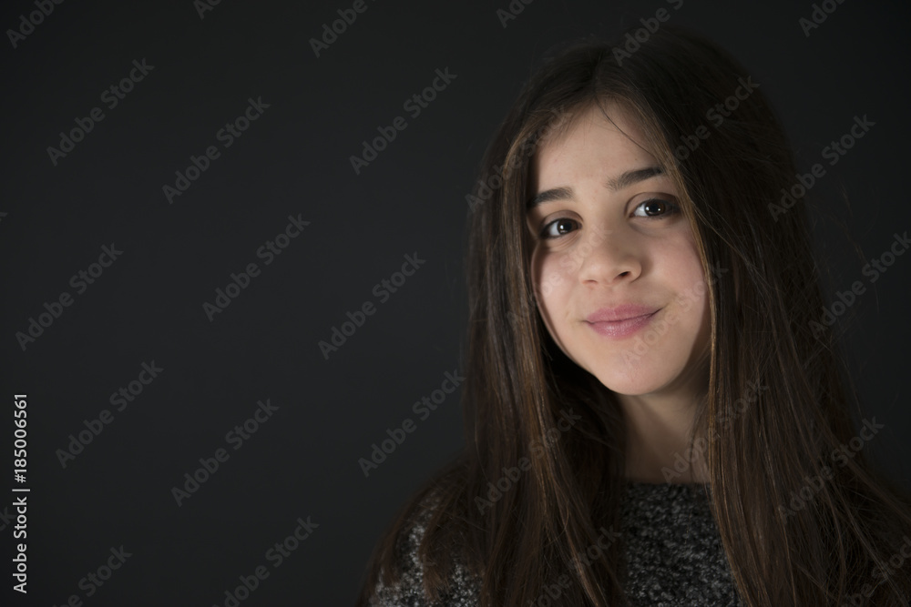 Fototapeta premium Portrait of a nice little girl on a black background