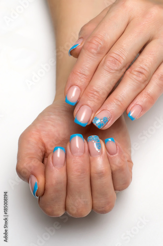 blue French manicure with flowers and crystals on short square nails  