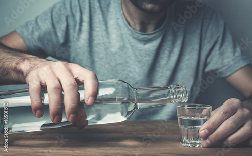 Caucasian alcoholic man with vodka. photo