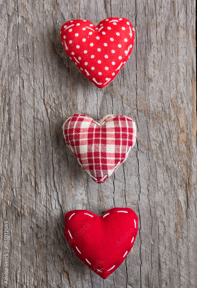 Three red hearts on wooden surface Three red hearts on wooden surface