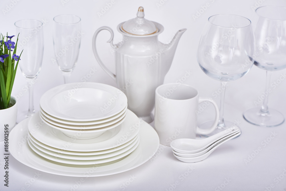 Set of new clean white dishes isolated on white background Set of new clean white dishes isolated on white background