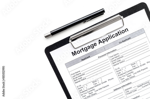 Mortgage application near apartment keys on white background top view copyspace