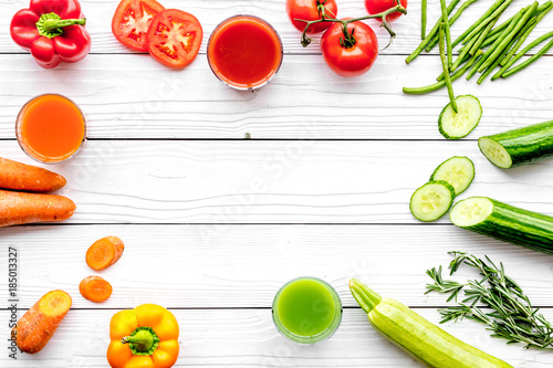 Wellness elements. Colorful detox drinks with vegetables on white wooden background top view copyspace