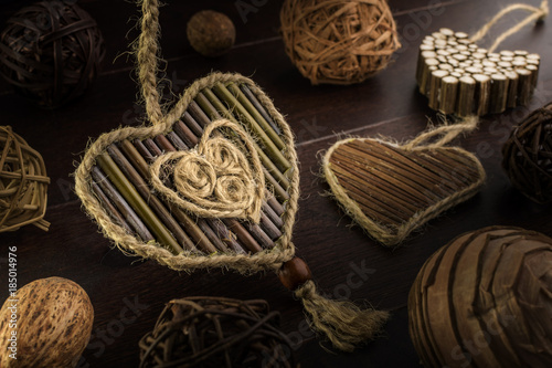 Composition with hearts from twigs on a wooden background.