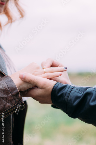 the guy makes an offer to marry his beloved girl, wears a ring. close-up