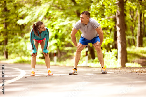 Fitness couple stretching outdoors in park