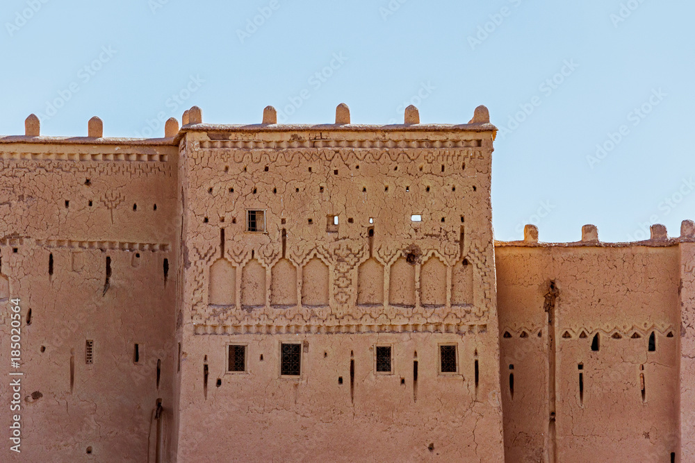traditional Moroccan clay building with blue sky 