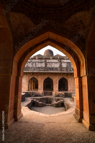 Mandu India, afghan ruins of islam kingdom, mosque monument and muslim tomb. View through door, Jahaz Mahal.