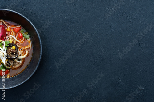 Ramen dish on dark background. Traditional Asian fast food meal. Delicious noodle soup