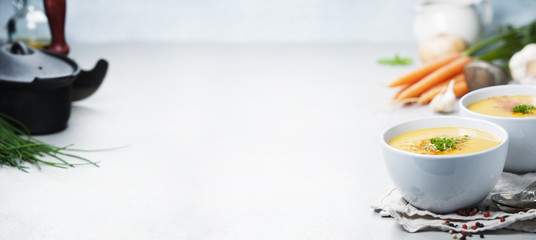 Vegetable cream soup in bowl over grey concrete background