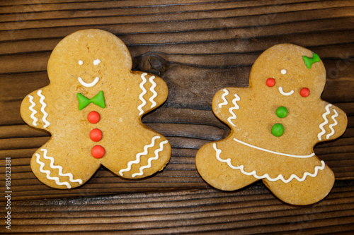 Christmas gingerbread couple cookies on wooden table. Top view