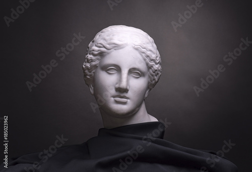 Gypsum bust isolated on black background, student work