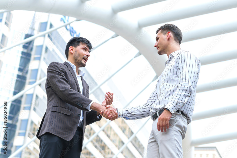 Two business man meeting partnership and shaking hands for deal success at site outdoors. Two business man meeting partnership and shaking hands for deal success at site outdoors.
